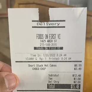 a hand holding a receipt