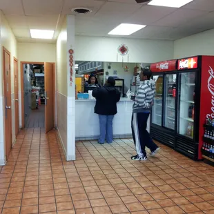 a man and a woman standing at the counter
