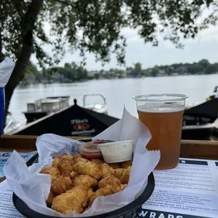 a basket of fried food and a glass of beer