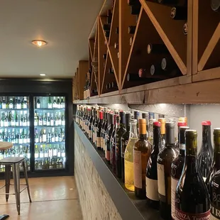 a row of wine bottles on a shelf