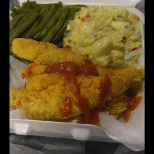 a takeout container with chicken, mashed potatoes and green beans