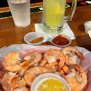 a plate of shrimp with dipping sauce