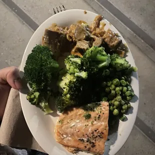 a person holding a plate of food