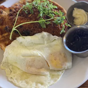 Chicken and waffles with over easy eggs