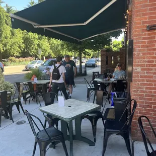 a patio with tables and chairs