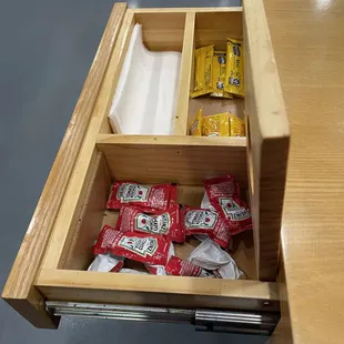 Hidden drawer with condiments/napkins.