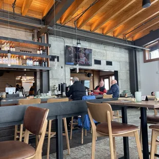 people sitting at tables in a restaurant