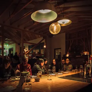 a group of people sitting at a table in a restaurant