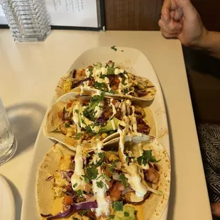 a plate of tacos and a glass of water