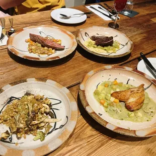Heirloom grain risotto (bottom left), catfish( bottom right), duck breast (top left), grilled sirloin( top right)