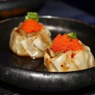 The Shumai are shrimp &amp; pork dumplings topped with garlic tamari sauce, masago, and scallion.