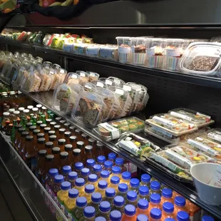 A plethora of to-go items: cupcakes, salads, sushi, sandwiches, drinks. Three cashiers makes for a quick pick up of lunch!