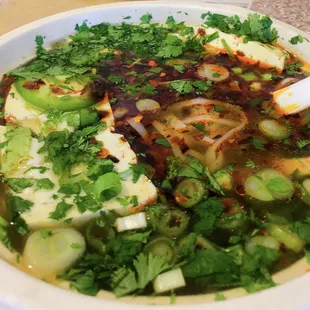 Tofu pho filled with their delicious spicy oil with extra onions.