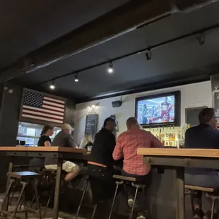 a group of people sitting at a bar