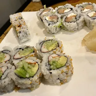 a plate of sushi and a plate of avocado