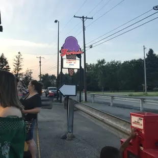 people waiting at a bus stop