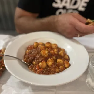 Gnocchi with their Bolognese sauce and add the sprinkled fresh Parmesano Reggiano it makes the dish