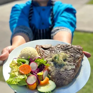 a young boy holding a plate of food