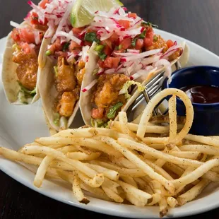 a plate of fish tacos and fries