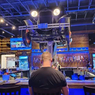 a bar with people sitting at the bar