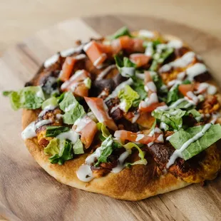 a pizza on a wooden board