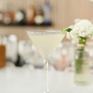 a martini with a lime garnish