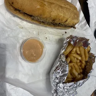 Philly Cheesesteak with onions, peppers and provolone, fries and fry sauce.