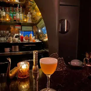 a glass of beer on a bar counter