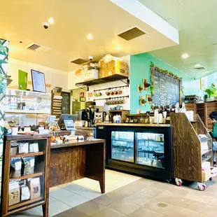a woman sitting at a counter in a coffee shop