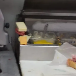 Yep those are random meats and cheeses sitting on the side of the condiment cooler.  Maybe they'll go into a sandwich later.