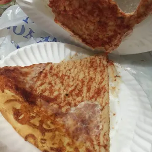 two slices of pizza on paper plates