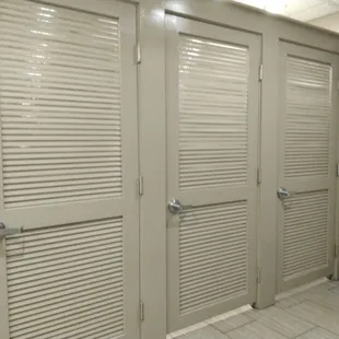 a row of doors in a public restroom