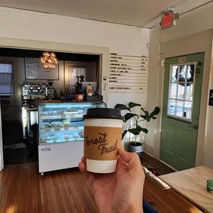 a person holding a cup of coffee