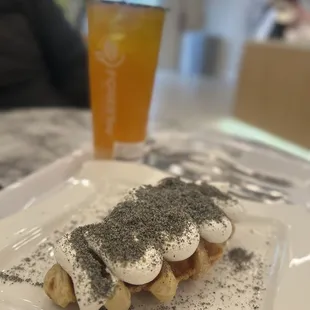 a dessert on a plate with a drink in the background