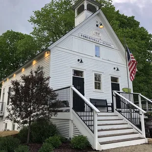 a white building with stairs leading up to it