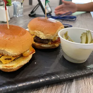 two burgers with pickles
