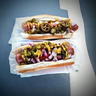 two hot dogs with toppings