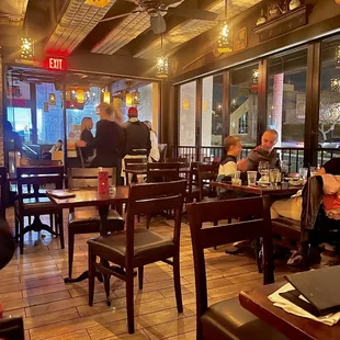 people sitting at tables in a restaurant