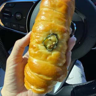 a person holding a donut in their hand