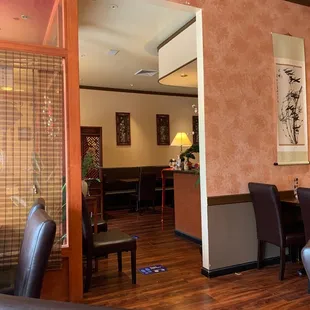 a view of a dining room with a table and chairs