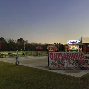 The truck is parked on a concrete pad adjacent to a golf driving range. It is clean and well-lit.