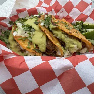 Birria tacos with green salsa added