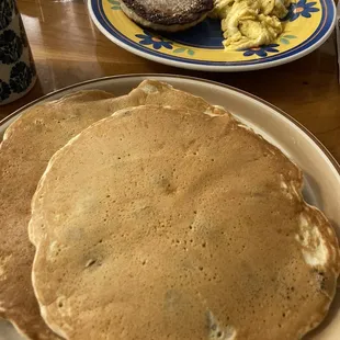 Blueberry pancakes with scrambled eggs and sausage patty