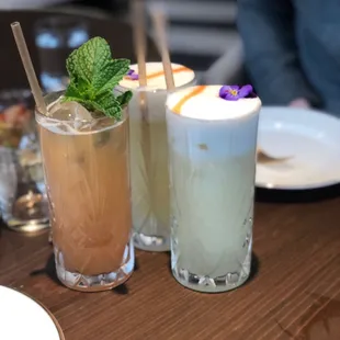 three different drinks on a table