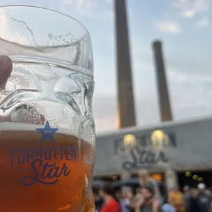 a person holding a glass of beer