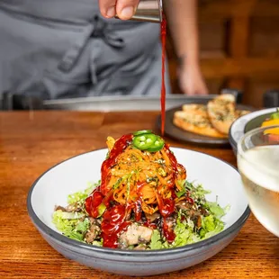 Chili sauce poured over bibimbap