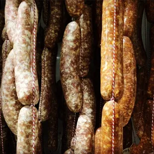 Tripel Pigs Salami, No. 1 Salami, El Diablo Chorizo hanging in our curing chamber. They cure and are ready to eat in 4-6 weeks.