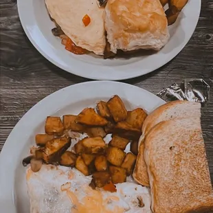 2 omelets with potatoes, biscuit and toast.