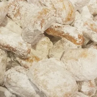 a tray of powdered sugared donuts