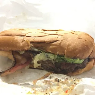Burger with cheddar and applewood bacon on a Genova Roll